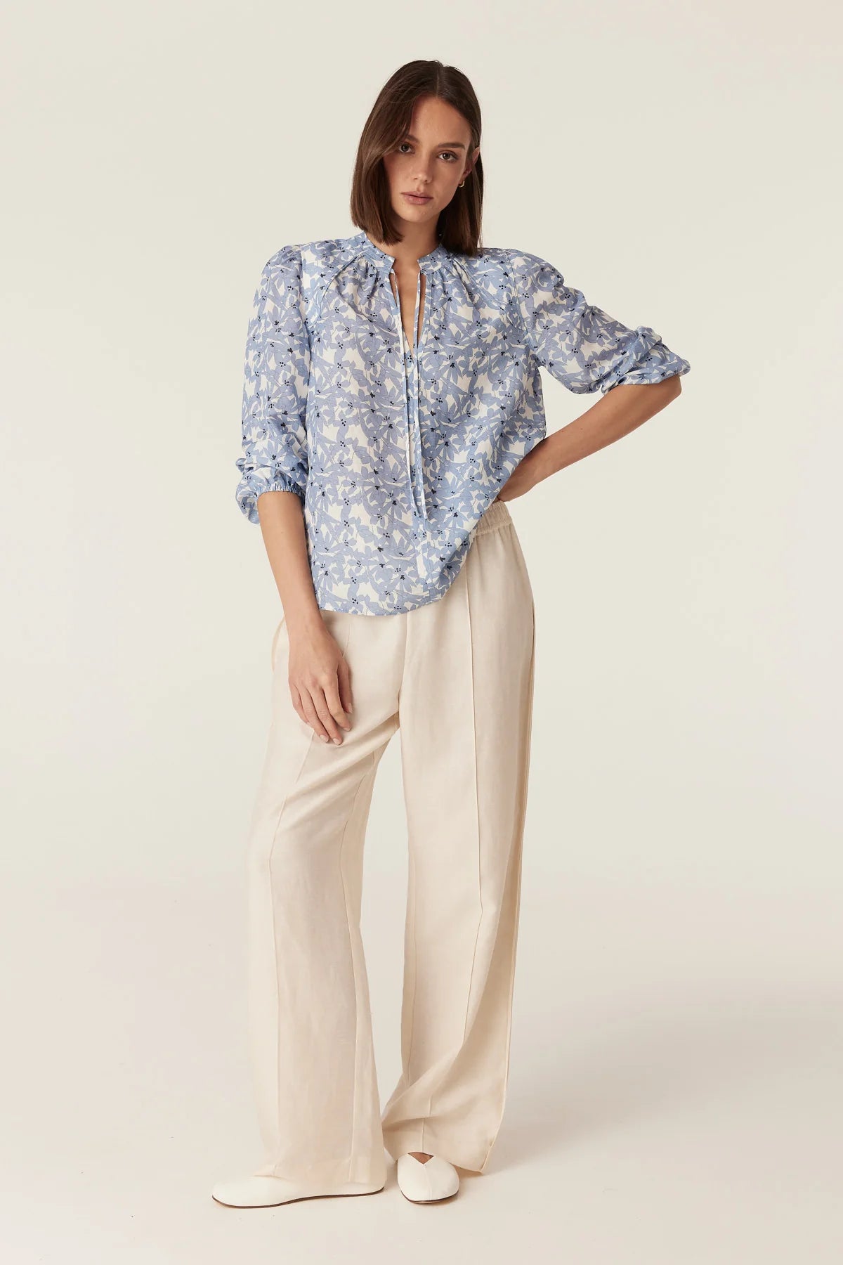Cable Melbourne Juliette Blouse in Blue Flower print, worn with cream wide-leg trousers - front view