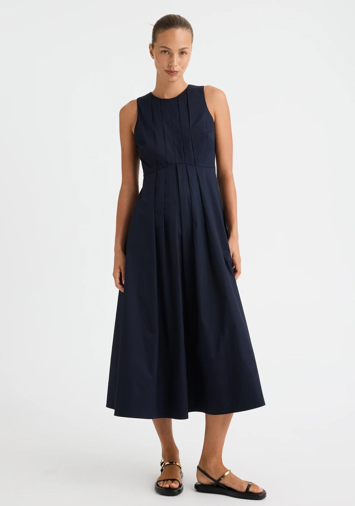 Morrison Maddison Dress in Navy, worn - front showing the pleated A-line midi skirt