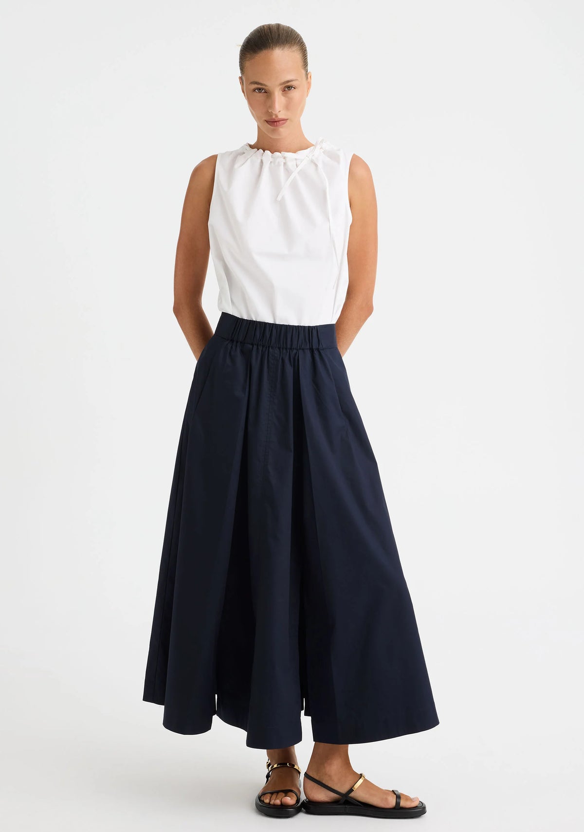 Morrison Maddison Skirt in Navy, worn - front, styled with a white sleeveless top