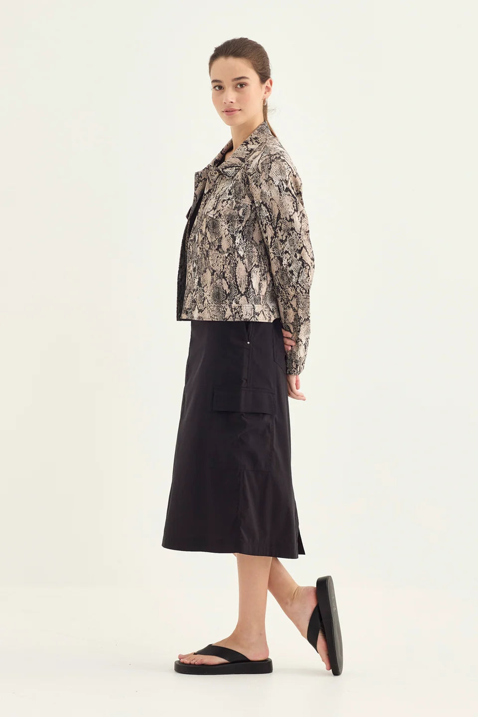 Verge Acrobat Porter Skirt in Black, worn - side showing cargo pocket